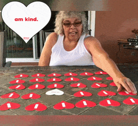 People Playing the affirmation matchdeck, flipping over I am kind and I am happy